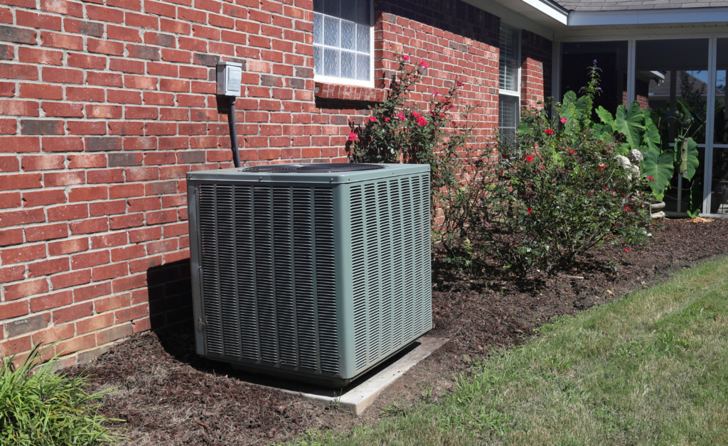 An air conditioning unit situated on the side of a residential home.